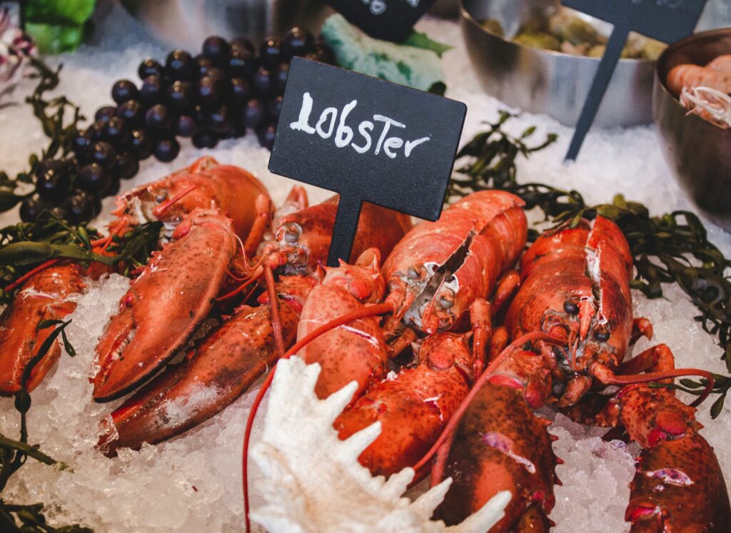 Cooking Lobster Tails on a serving platter with melted butter, lemon wedges, and tender seafood meat ready to enjoy.