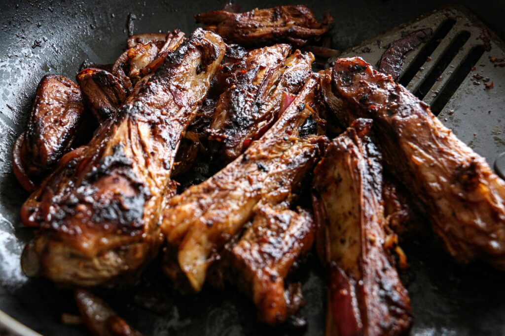 Juicy oven-baked ribs with a savory barbecue glaze, cooked until tender and served fresh from the oven.