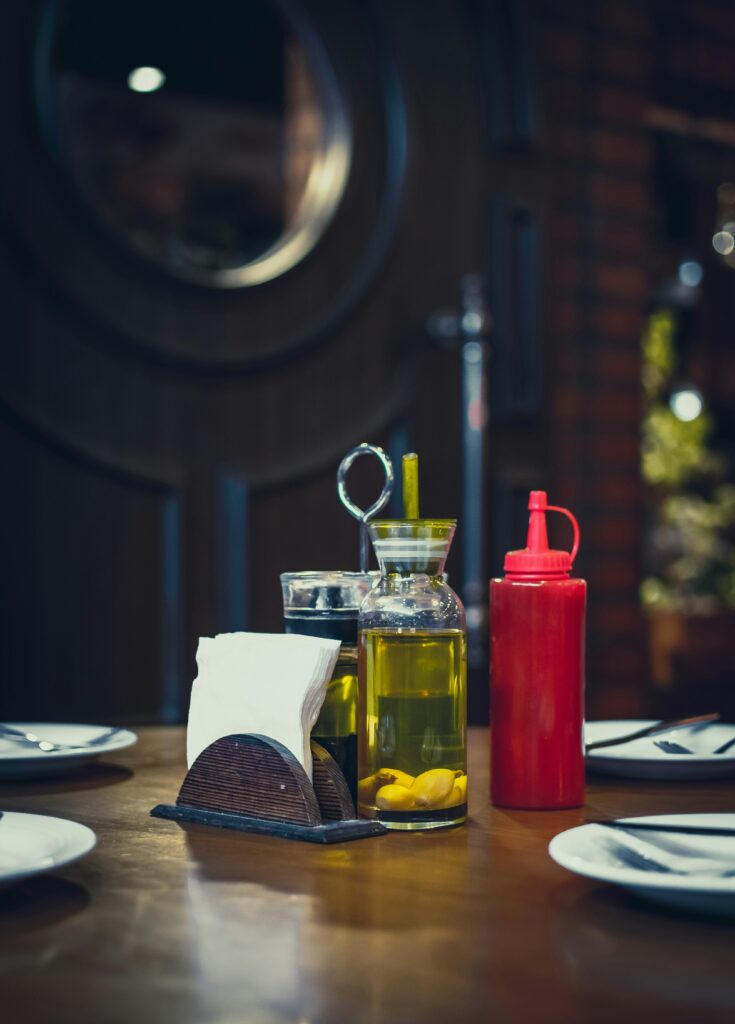 Canola oil pouring into a pan — exploring why is canola oil banned in Europe.